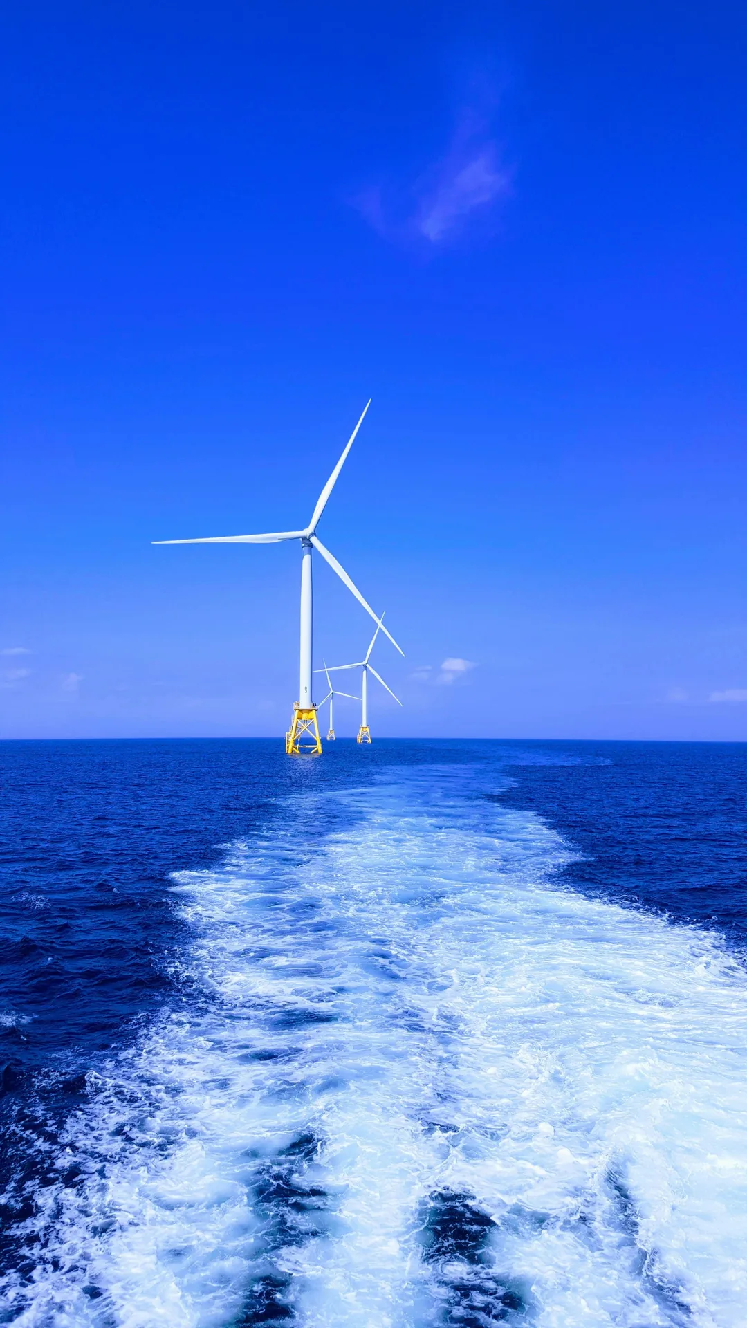 Offshore wind farm turbines rising from the sea